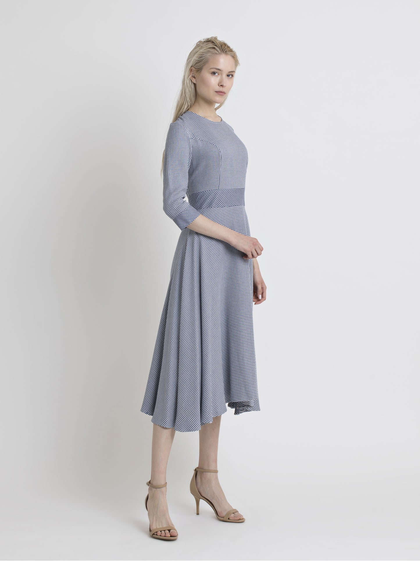 Asymmetric knee length dress with a closed neck and elbow sleeve. Blue and white star design viscose cotton fabric