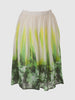 Knee length elastic gathered off white skirt with green leafy print around the hem and smudge yellow strikes going up to the waistline 