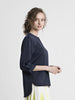 Navy blue satin blouse featuring high crew neck, elbow sleeve, and gold color buttons