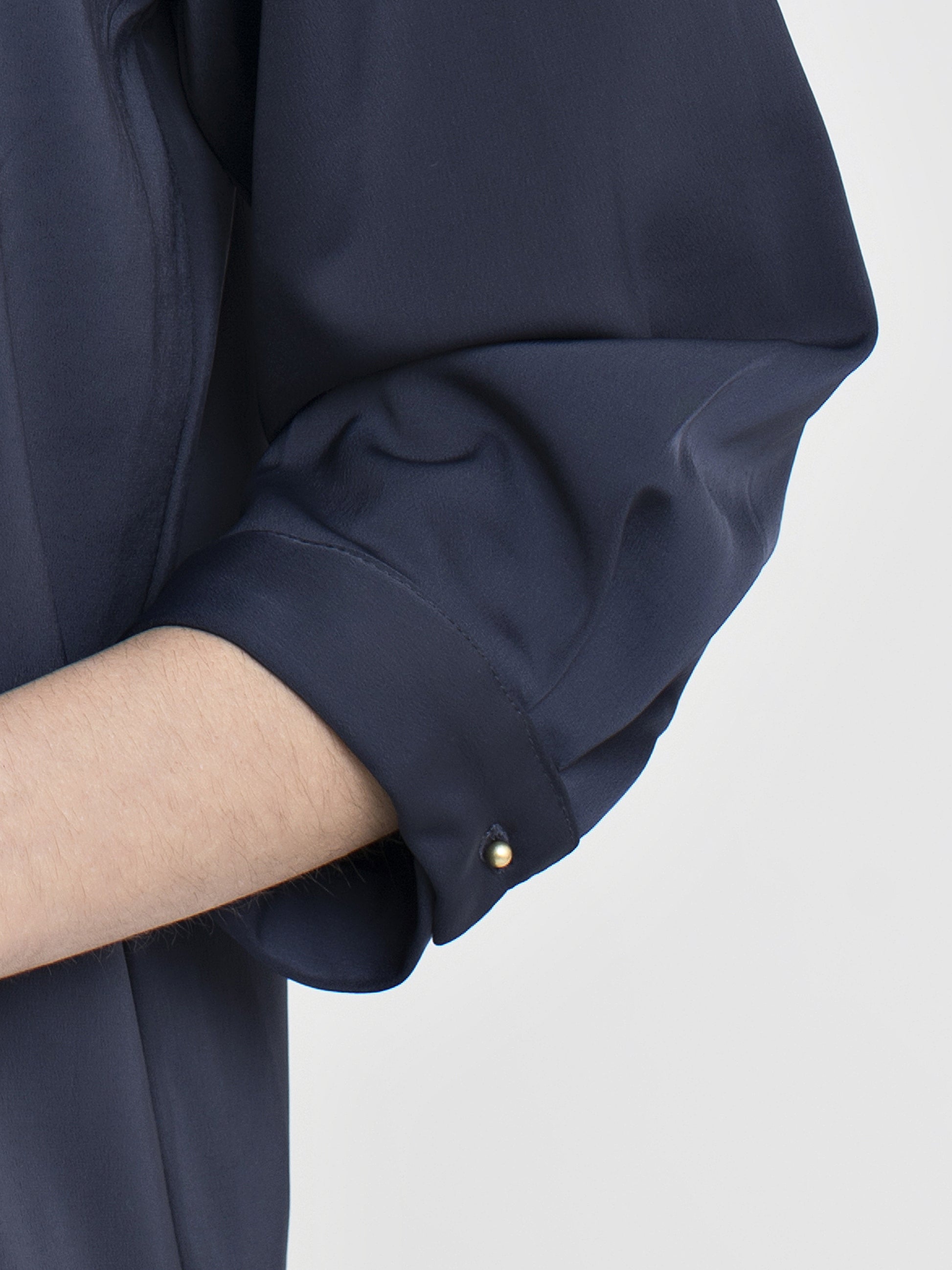 Navy blue satin blouse featuring high crew neck, elbow sleeve, and gold color buttons