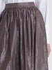 Hip close up view of a female model wearing a white dress shirt, and a glossy earth color gathered skirt from the RÉZO women's collection. 